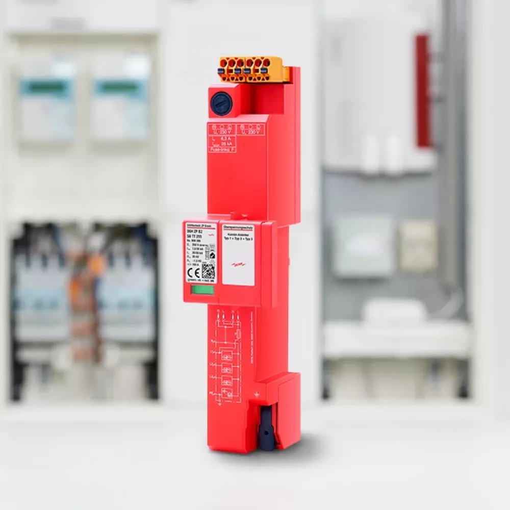 Rotes elektronisches Gerät mit Anschlüssen in technischer Umgebung.