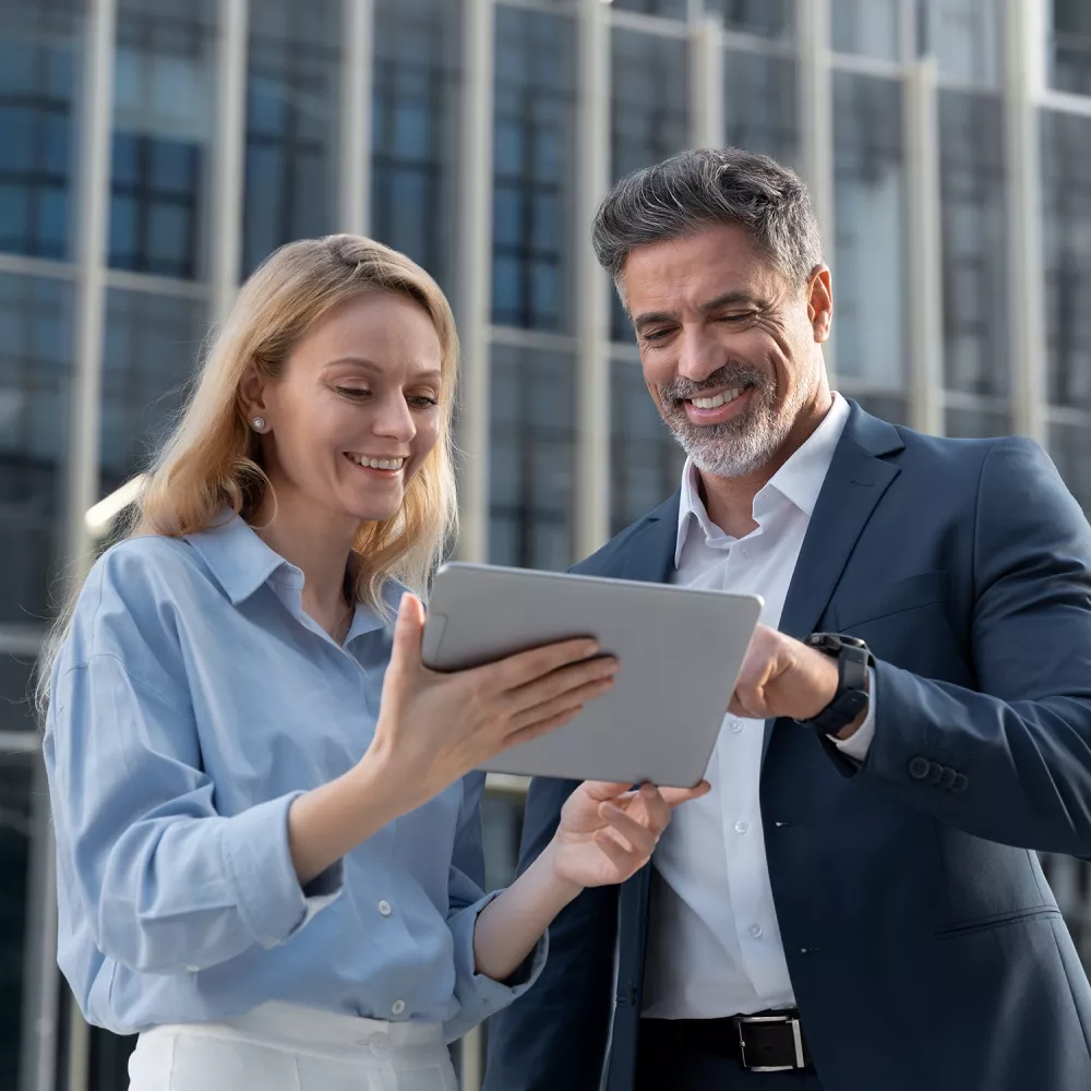 buiness woman and man looking at a tablet