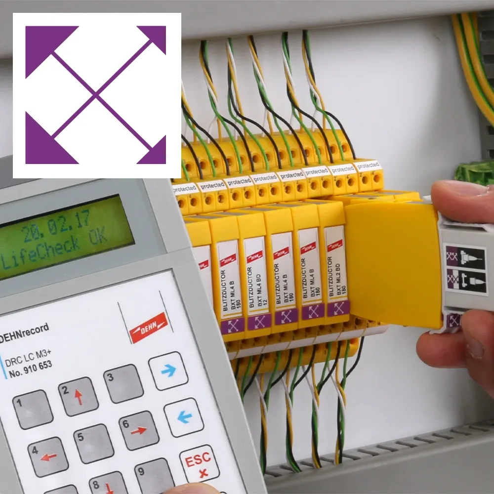 Electrical control cabinet with yellow surge protection modules, connected wires, handheld measuring device, and purple arrow icon overlay.