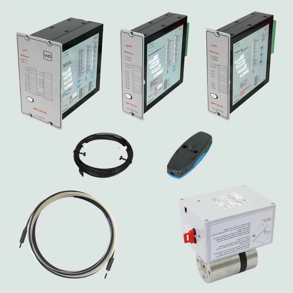 Set of electrical protection components including three control modules, coiled cables, a sensor unit, and a cylindrical actuator on a light background.